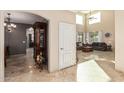 Grand entryway leading into a spacious living room with natural light and high ceilings at 42531 W Chisholm Dr, Maricopa, AZ 85138