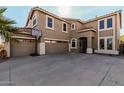 Lovely curb appeal with a wide driveway and a three-car garage at 42531 W Chisholm Dr, Maricopa, AZ 85138