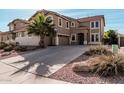 A beautiful exterior shot showing the home's driveway and desert landscaping at 42531 W Chisholm Dr, Maricopa, AZ 85138