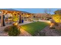 Relaxing backyard with pool, pergola, and landscape lighting at 4907 W Faull Dr, New River, AZ 85087