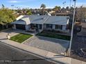 Aerial shot of a single-story home with desert landscaping, and a two-car garage at 5045 W Mescal St, Glendale, AZ 85304