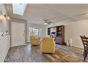 Bright living room featuring a skylight, hardwood floors, and stylish furniture at 5045 W Mescal St, Glendale, AZ 85304