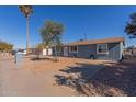 Newly painted home with front yard landscaping and walkway at 6033 S 19Th Pl, Phoenix, AZ 85042