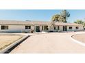 Front view of a charming ranch house with a long driveway at 6212 S 37Th St, Phoenix, AZ 85042