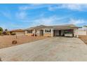 Ranch style home with carport, solar panels, and landscaped yard at 6252 E Billings St, Mesa, AZ 85205