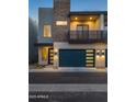 Modern two-story home featuring a blue garage door, brick accents, and a second-story balcony at 6301 N 12Th St # 8, Phoenix, AZ 85014