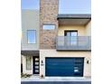 Modern two-story home featuring a private balcony and a blue garage door at 6301 N 12Th St # 8, Phoenix, AZ 85014