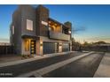 Contemporary home boasts a long driveway leading to a two-car garage, showcasing sleek architectural design at 6301 N 12Th St # 8, Phoenix, AZ 85014