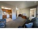 Living room features a view into the kitchen and access to other rooms at 867 E Lancaster Cir, Florence, AZ 85132