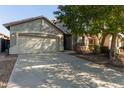 Two-story house with beige exterior, two car garage and mature landscaping at 88 E Macaw Ct, San Tan Valley, AZ 85143