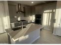 Modern kitchen with gray cabinets, island, and stainless steel appliances at 9227 E Sector Dr, Mesa, AZ 85212