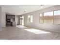 Bright and spacious living room with wood-look floors, recessed lighting, and large windows for natural light at 9227 E Sector Dr, Mesa, AZ 85212