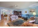 Living room with floral couches and built-in shelving at 9502 W Shasta Dr, Sun City, AZ 85351