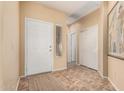 Inviting foyer with neutral walls, tile flooring, and ample closet space for coats and storage at 9746 E Coopers Hawk Dr, Sun Lakes, AZ 85248