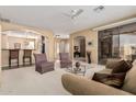 Bright living room featuring a ceiling fan, sliding glass door, and seamless access to other rooms at 9746 E Coopers Hawk Dr, Sun Lakes, AZ 85248