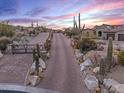 Long private driveway leading to a beautiful estate in a luxurious community at 10473 E Greythorn Dr, Scottsdale, AZ 85262