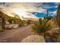 Landscaped entry with brick pavers and desert plants at 10473 E Greythorn Dr, Scottsdale, AZ 85262