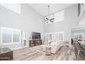 Spacious living room with high ceilings, hardwood floors, and large windows at 10789 W Yearling Rd, Peoria, AZ 85383