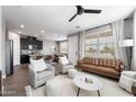 Bright open-concept living room features modern furnishings, a stylish ceiling fan, and lots of natural light at 1255 N Arizona Ave # 1331, Chandler, AZ 85225