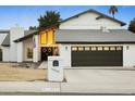 Modern two-story house with dark brown garage doors and a manicured lawn at 13026 N 12Th Ave, Phoenix, AZ 85029