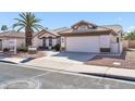 Front view of a single-story house with a two-car garage at 14949 W Robson Cir, Goodyear, AZ 85395