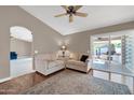 Living room with hardwood floors, neutral walls, and access to a patio at 14949 W Robson Cir, Goodyear, AZ 85395