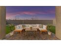 Relaxing backyard patio with sectional sofa and coffee table, perfect for outdoor entertaining at 17574 W Cardinal Dr, Goodyear, AZ 85338