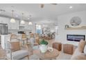 Open concept kitchen and living area, featuring modern appliances and a fireplace at 17574 W Cardinal Dr, Goodyear, AZ 85338