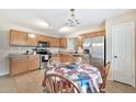 Kitchen with ample cabinetry, stainless steel appliances, and breakfast nook at 18963 N Vemto St, Maricopa, AZ 85138