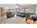 Spacious living room featuring a sectional sofa and access to the kitchen at 18963 N Vemto St, Maricopa, AZ 85138