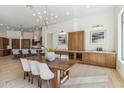 Spacious dining room featuring a wooden table with seating for six and built-in cabinets with a wine cooler at 19910 N 84Th St, Scottsdale, AZ 85255