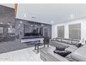 Stylish living room features a marble accent wall and a comfortable sectional sofa at 2037 E Riviera Dr, Tempe, AZ 85282