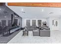 Open concept living room with a modern fireplace and large sectional at 2037 E Riviera Dr, Tempe, AZ 85282