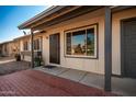 Front entrance with a black metal door and brick walkway at 2331 W Onza Ave, Mesa, AZ 85202