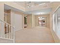 Bright living room with a view to the backyard pool through sliding glass doors and a staircase visible at 26234 W Behrend Dr, Buckeye, AZ 85396