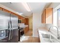 Modern kitchen with stainless steel appliances and wood cabinets at 3703 E Mitchell Dr, Phoenix, AZ 85018