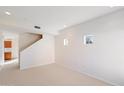 Spacious living room with neutral carpet and stairway at 3703 E Mitchell Dr, Phoenix, AZ 85018
