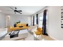 Bright living room with yellow couch and white coffee table at 3714 E Amelia Ave, Phoenix, AZ 85018