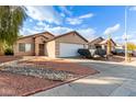 Tan house with white garage door and landscaping at 4510 N 84Th Ave, Phoenix, AZ 85037
