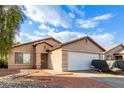 Tan house with white garage door and landscaping at 4510 N 84Th Ave, Phoenix, AZ 85037