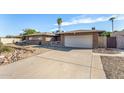Front view of a ranch home with a two-car garage and gravel driveway at 4511 W Sandra Ter, Glendale, AZ 85306