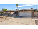 House exterior showcasing a two-car garage and well maintained yard at 4511 W Sandra Ter, Glendale, AZ 85306