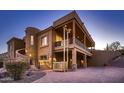 Contemporary home with a unique three-car garage lift and exterior finishes at 4590 S Gold Canyon Dr, Gold Canyon, AZ 85118