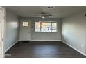 Bright living room with new flooring and ceiling fan at 4643 W Caron St, Glendale, AZ 85302