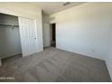 Bedroom featuring plush carpeting, closet, neutral paint, and a bright and airy feel at 46905 W Old Timer Rd, Maricopa, AZ 85139