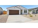 Attractive single-story home with a stucco facade, brown trim, desert landscaping, and a two-car garage at 46905 W Old Timer Rd, Maricopa, AZ 85139