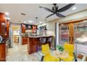 Entertain in this inviting kitchen, featuring a breakfast bar, stone floors and access to the backyard at 6720 E Phelps Rd, Scottsdale, AZ 85254