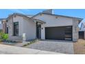 Beautiful modern home with neutral stucco, stone accents, stylish garage door and desert landscaping at 6727 N 9Th Dr, Phoenix, AZ 85013