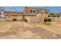 Tan two-story townhome with wood fence and landscaping at 8446 N 34Th Dr, Phoenix, AZ 85051