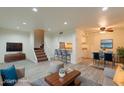 Open-concept living area with stairs, featuring modern decor and a seamless flow to the dining area at 8446 N 34Th Dr, Phoenix, AZ 85051